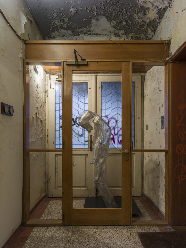 Installation view showing the metall humanoid in the exhibition space.