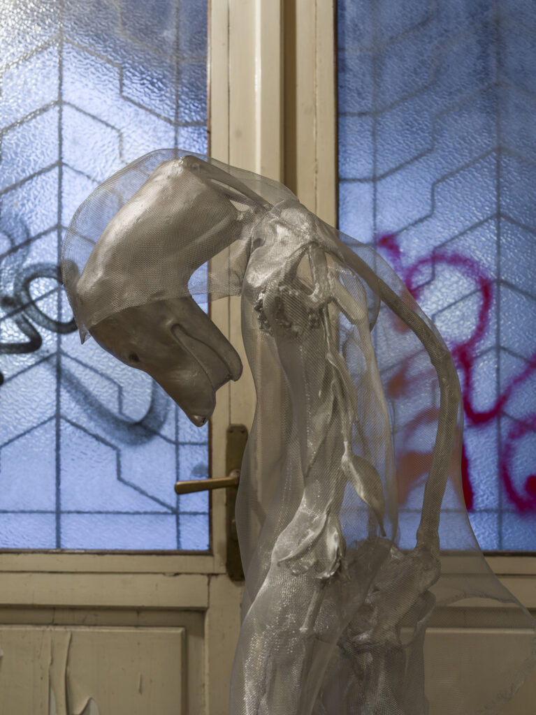 Installation view showing the metall humanoid in the exhibition space.
