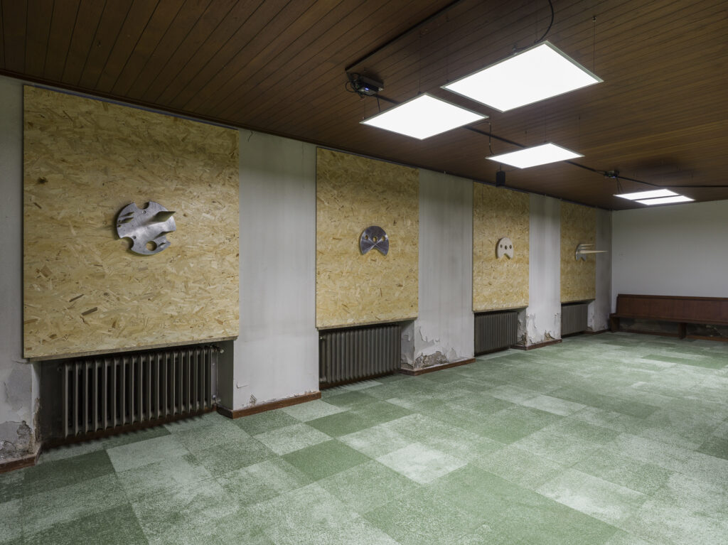 Installation view of art works mounted on the wall and speakers hanging from the ceiling for the sound installation.