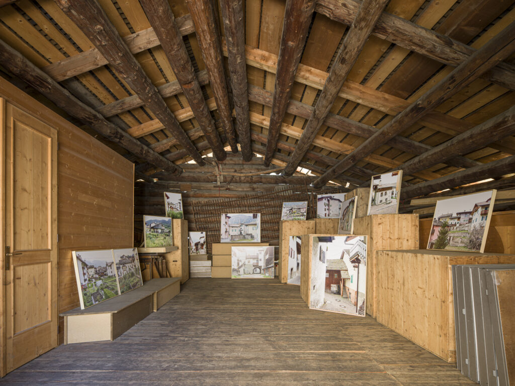 Installation view of framed photographs in a barn.