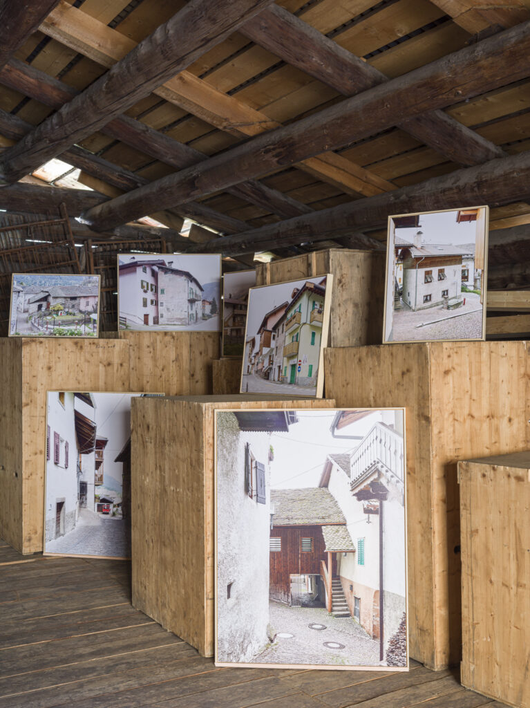 Installation view of framed photographs in a barn.