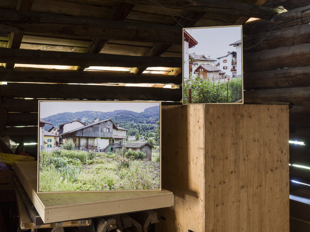 Installation view of framed photographs in a barn.