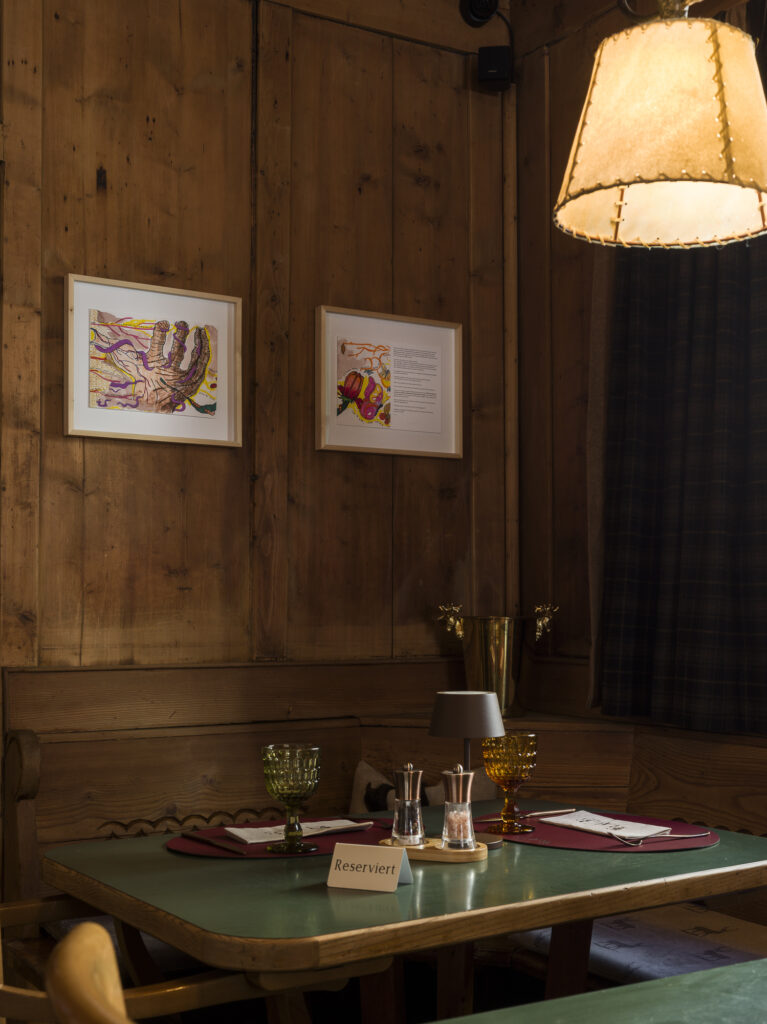 Installation view of framed drawings on the wall.