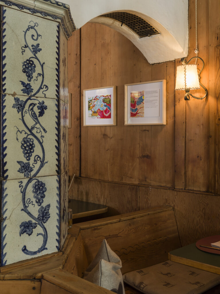 Installation view of framed drawings on the wall.