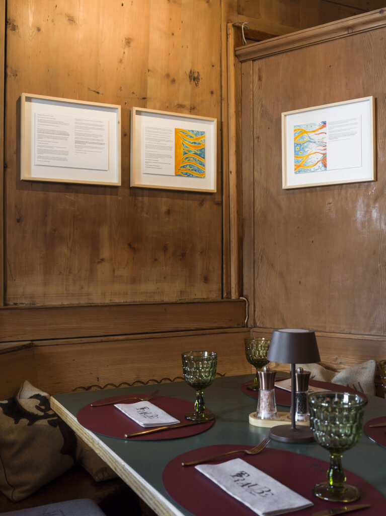 Installation view of framed drawings on the wall.