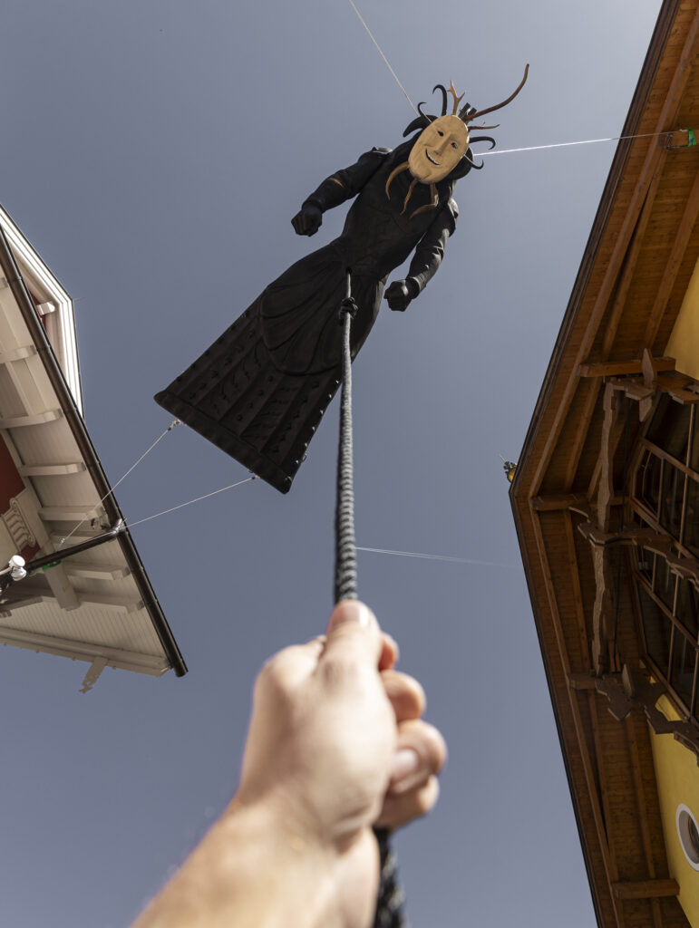 Installation view of a flying sculpture, installed between the roofs of Ortisei.