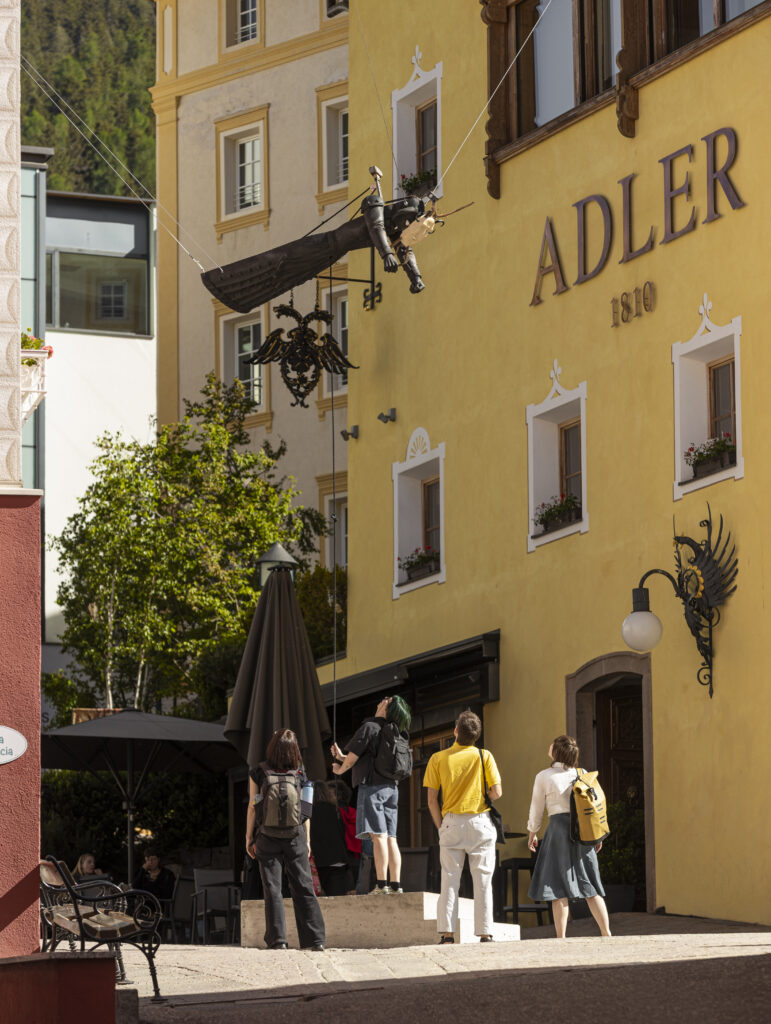 Installation view of a flying sculpture, installed between the roofs of Ortisei.