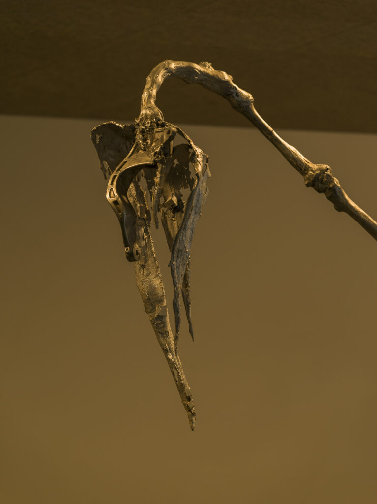 Installation view showing the metall flower in a dark exhibition space.